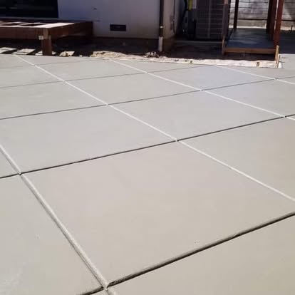 Broom-finished concrete patio with control joints cut in a clean grid