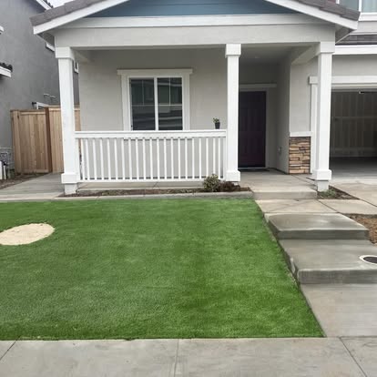 Artificial grass front lawn in front of a covered porch