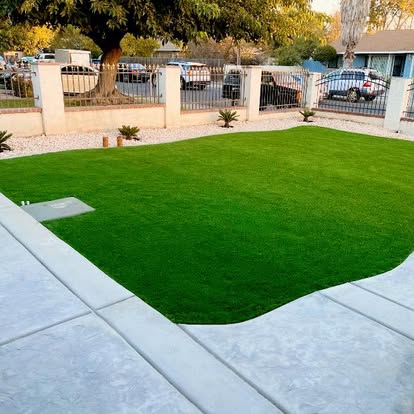 Front yard artificial grass lawn behind a low pillared wall