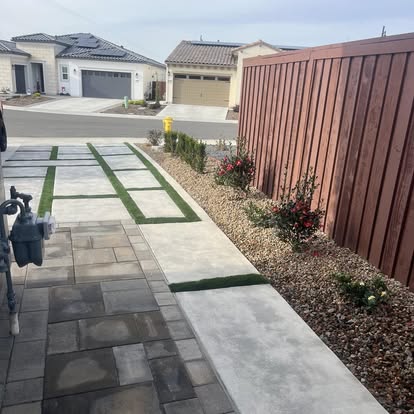 Paver walkway with turf joints leading along the side of a house