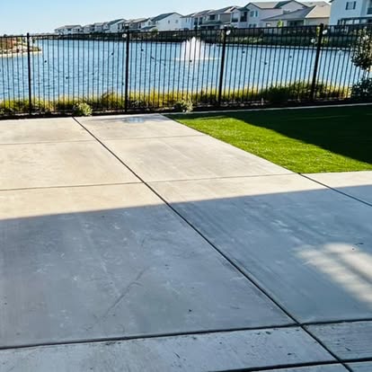 Concrete driveway with an artificial grass verge on a waterfront lot